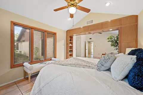 a bedroom with a large bed and a large window