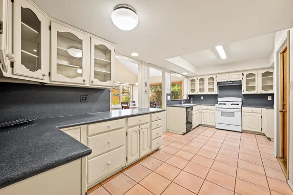 a kitchen with stainless steel appliances granite countertop a sink and cabinets