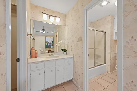 a en suite bathroom with a sink a mirror and a shower
