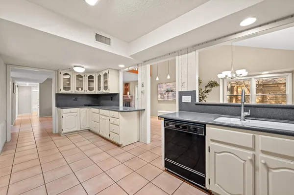 a kitchen with stainless steel appliances granite countertop a sink and cabinets