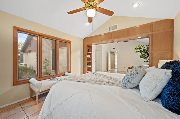 a bedroom with a large bed and a large window