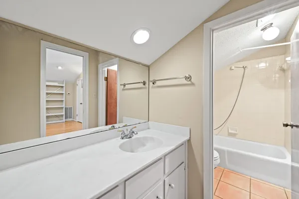 a view of a room with wooden floor and white walls