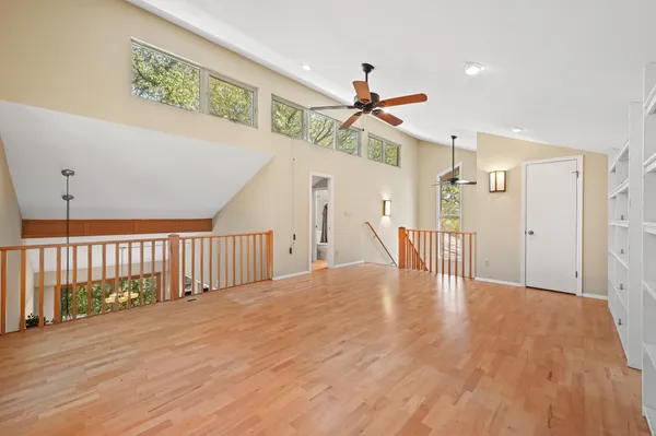 a view of a hallway with wooden floor and entryway