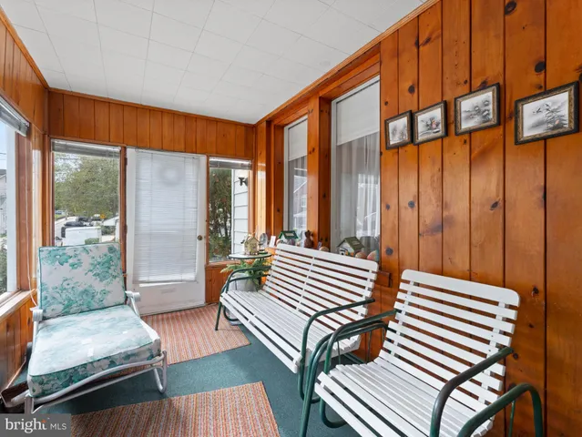 a bedroom with furniture and large window