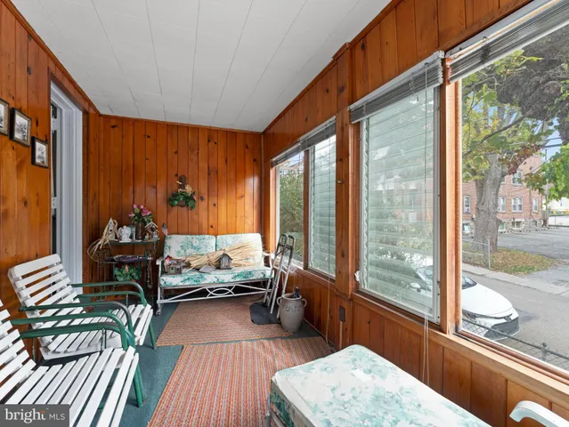 a living room filled with furniture and a large window