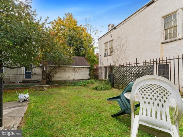 a view of a chair and table in the backyard