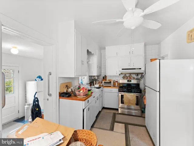 a kitchen with stainless steel appliances a stove a refrigerator and a sink