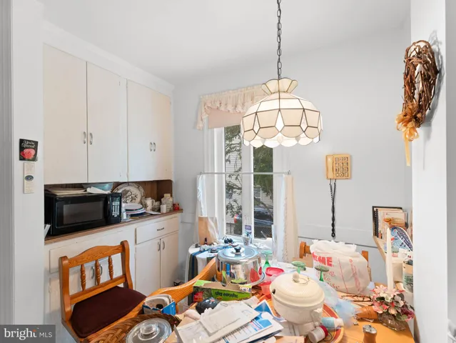 a bedroom with furniture a rug toys and a window