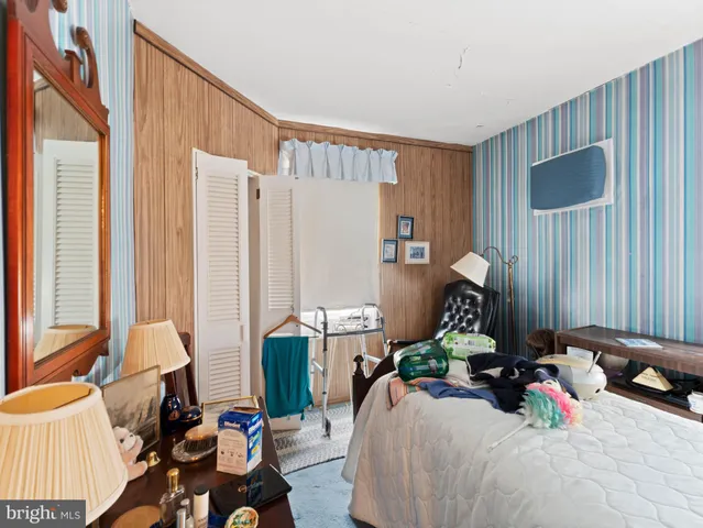 a bedroom with furniture and a window