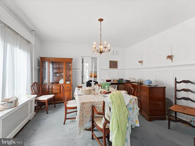 a living room with furniture a chandelier and a fireplace
