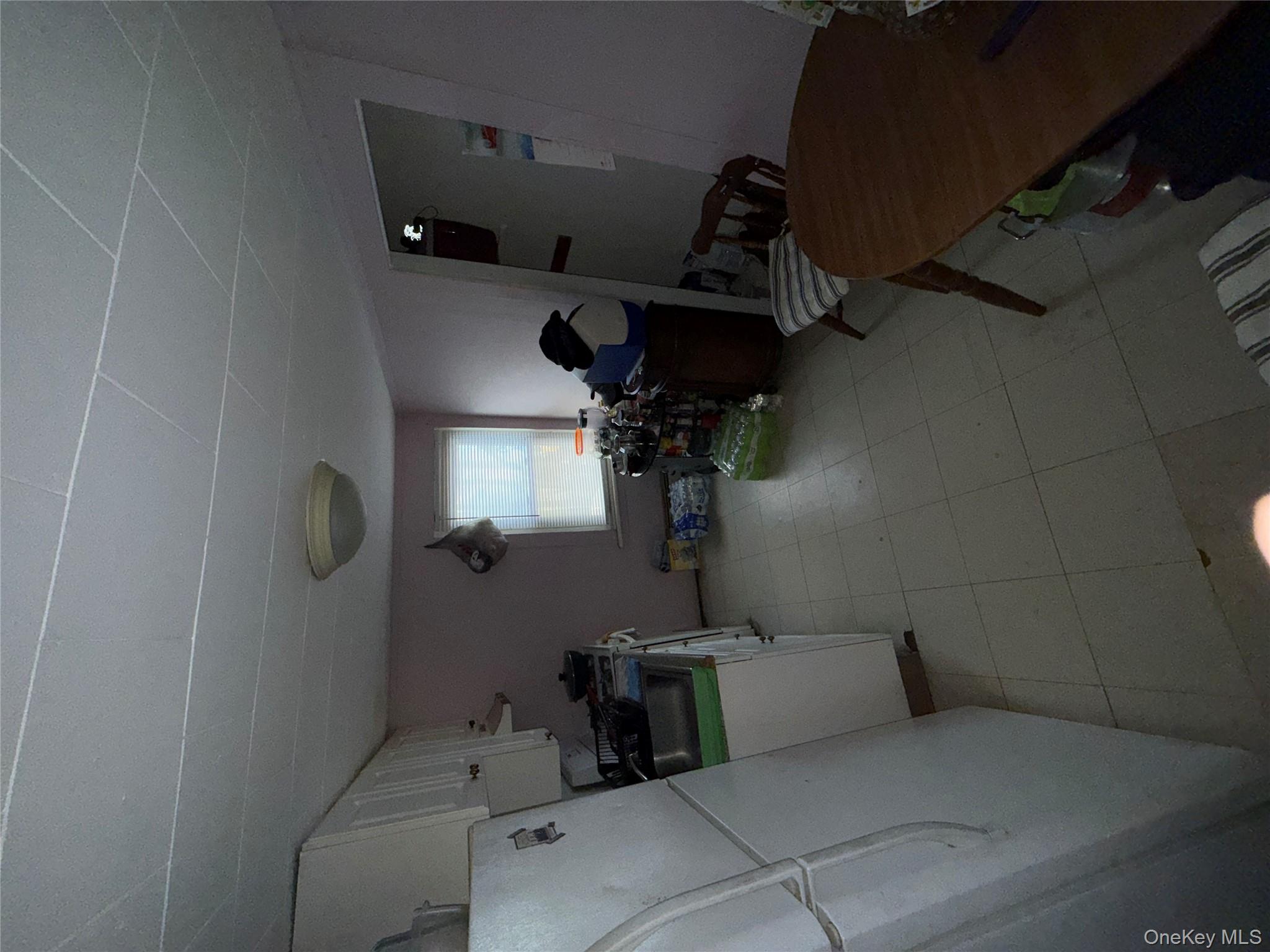 101 North Clinton Street Poughkeepsie, NY 12601 - Photo 7 of 11 Kitchen with white cabinetry, refrigerator, light flooring, light countertops, and stove