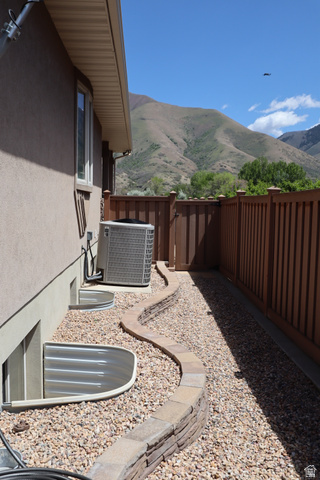 1055 North 1000 East Mapleton, UT 84664 - Photo 89 of 112 Stucco exterior with a stone-accented curved retaining wall and gravel landscaping