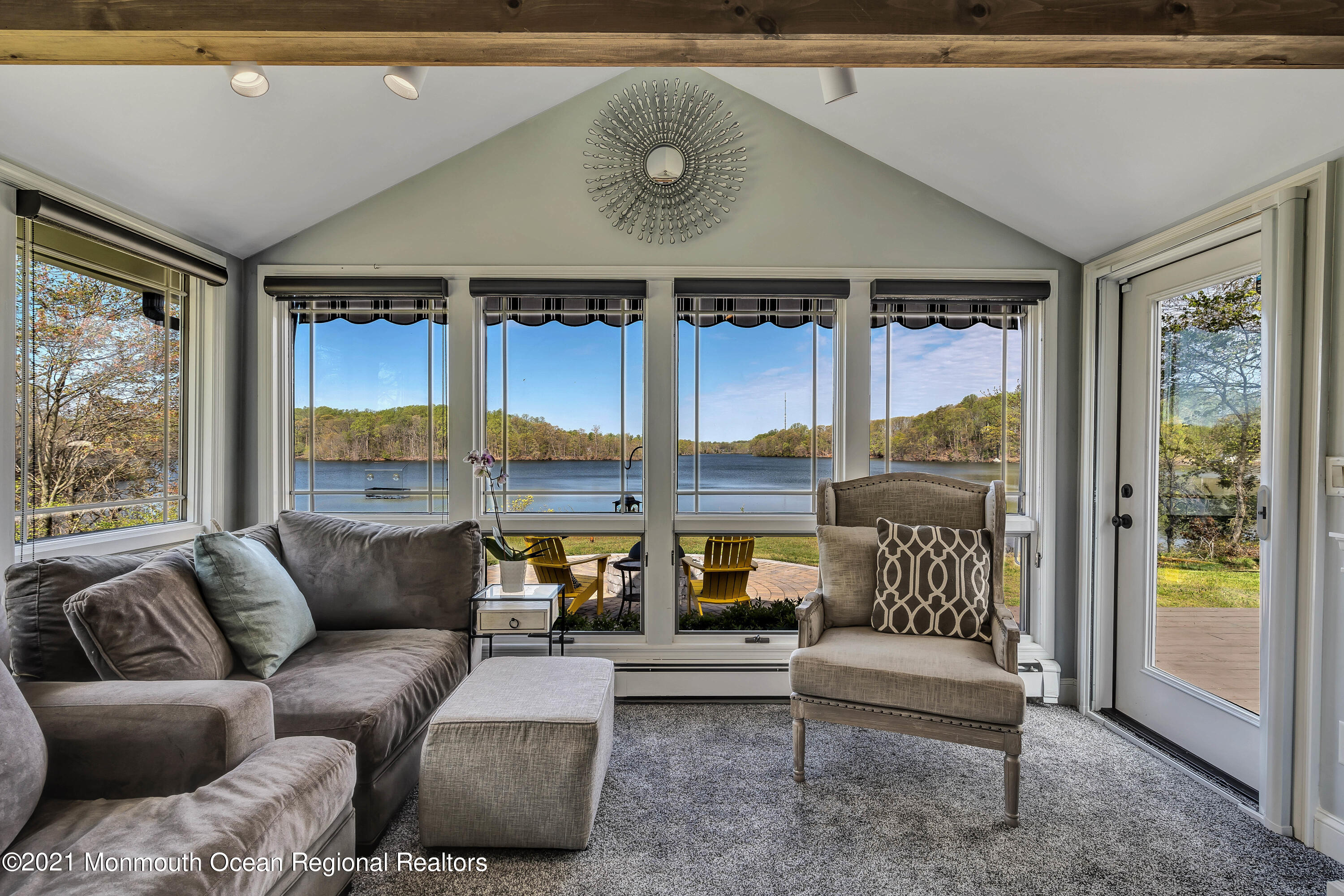 a living room with furniture and floor to ceiling window