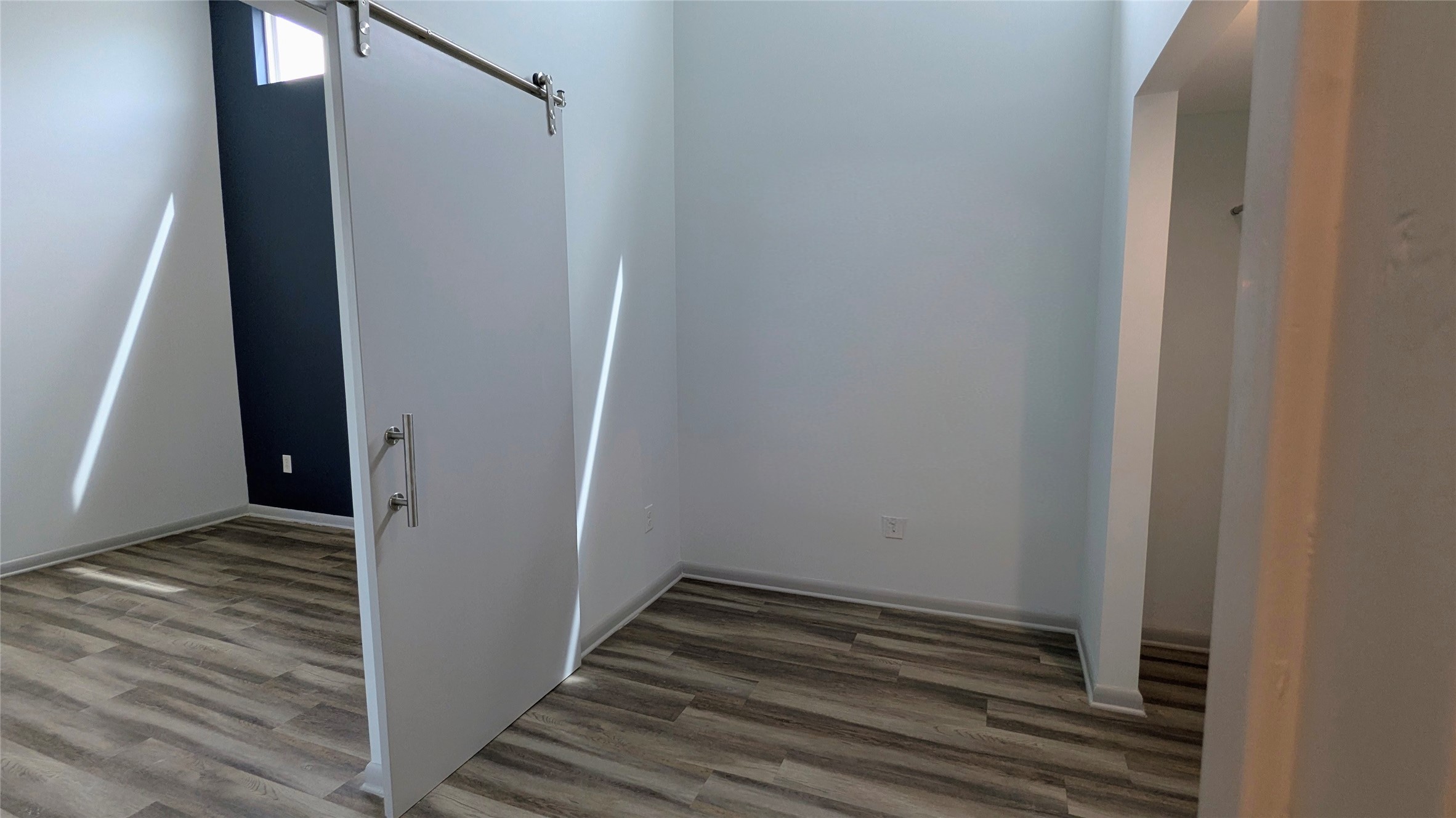 4505 Teri Road, Unit A Austin, TX 78744 - Photo 12 of 23 Versatile bonus room, featuring a closet and a modern barn door.