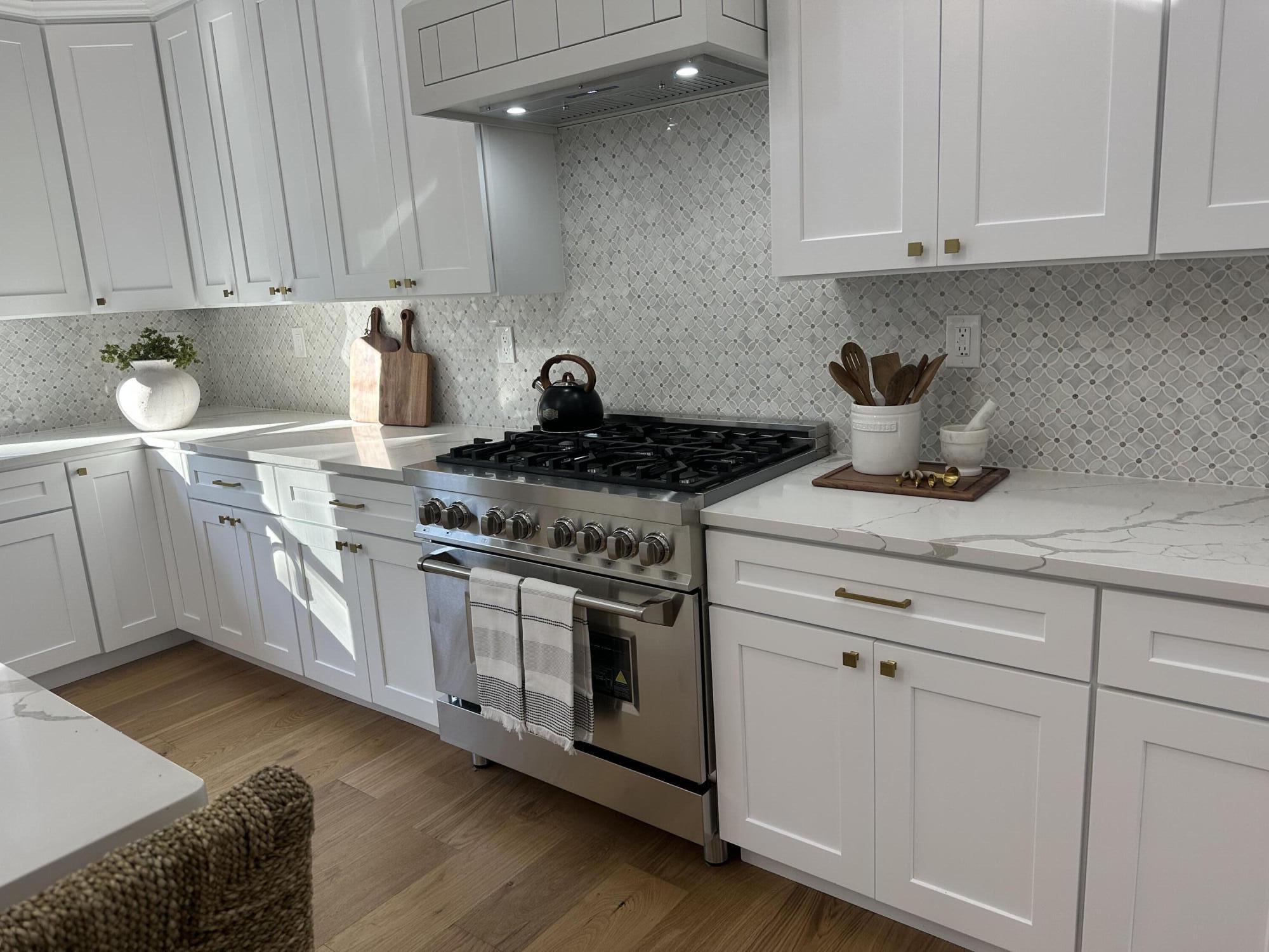 84 Hooppole Road Mashpee, MA 02649 - Photo 14 of 54 a kitchen with stainless steel appliances granite countertop a stove a sink and white cabinets