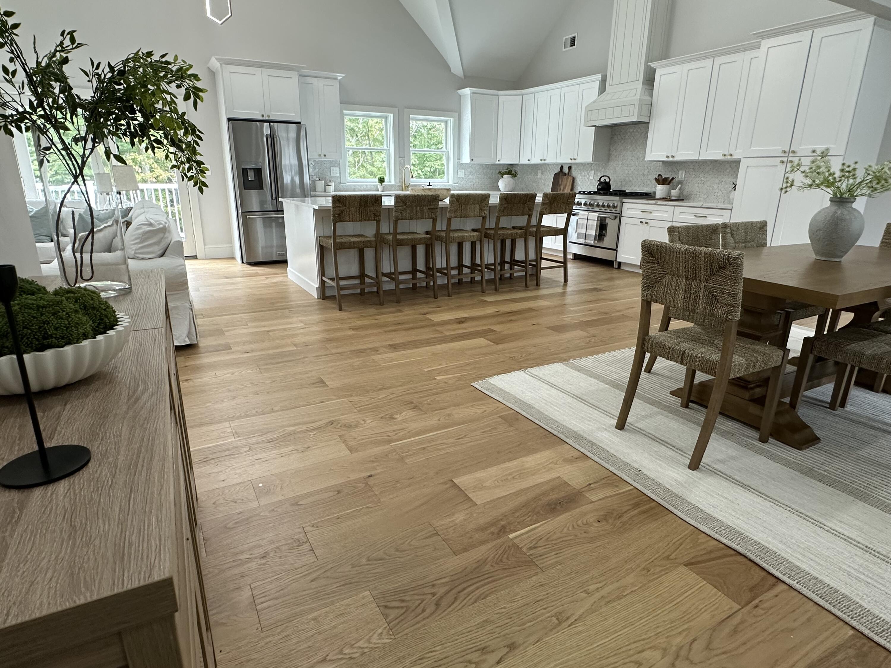 84 Hooppole Road Mashpee, MA 02649 - Photo 9 of 54 a kitchen with stainless steel appliances kitchen island granite countertop a table chairs sink and cabinets