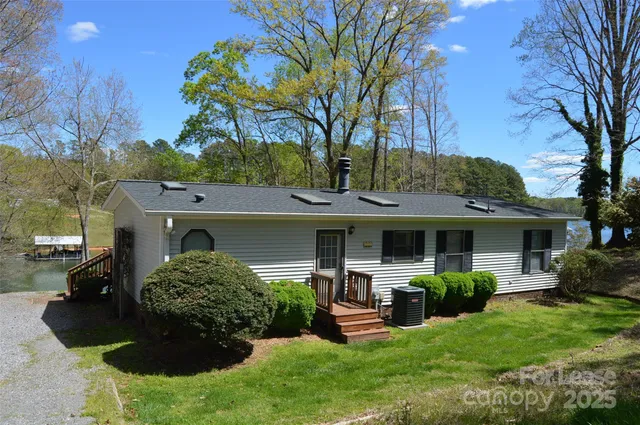 a view of a house with backyard sitting area and garden