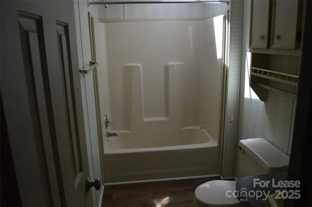 a bathroom with a shower and a toilet
