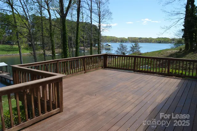 a view of balcony with wooden floor and fence
