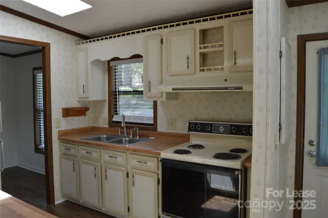 a kitchen with a sink stove and refrigerator