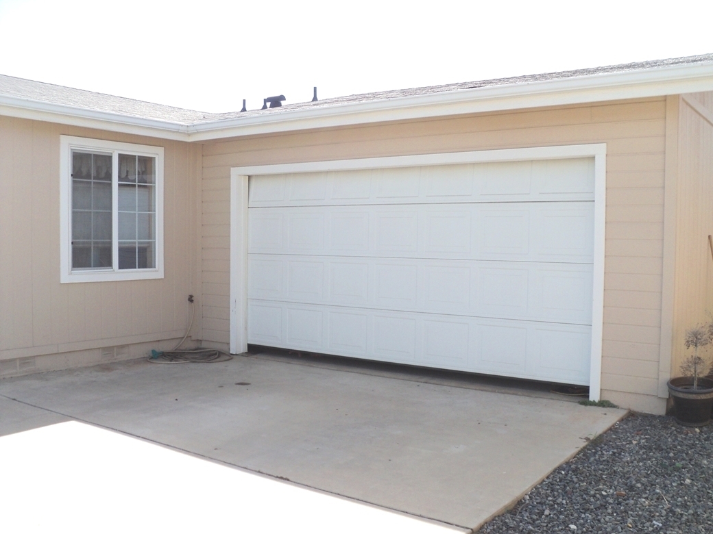 15935 Spring Oaks Road, Unit 112 El Cajon, CA 92021 - Photo 4 of 24 The garage has an automatic roll-up door with direct entry into the house. Another door leads out to the back yard.