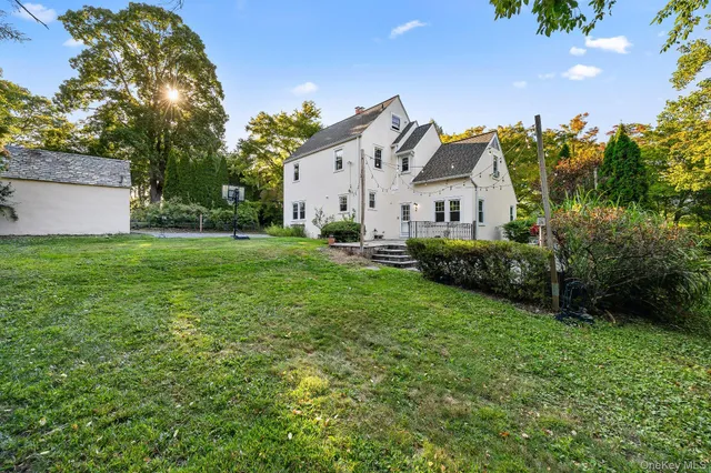 a view of a house with a big yard and potted plants