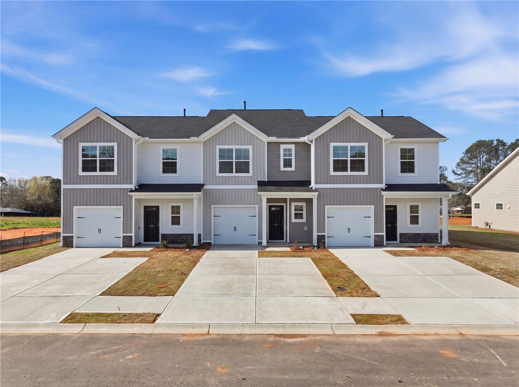 This modern townhome complex offers convenient individual garages and inviting entrances.