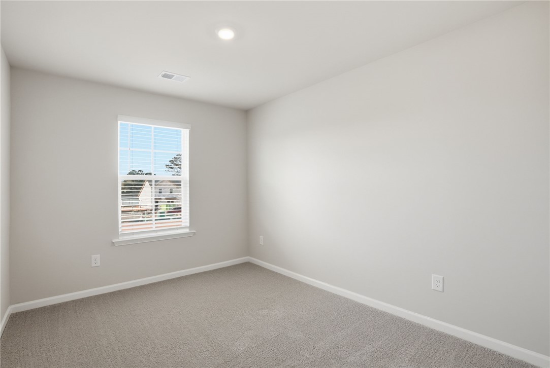 112 Lilac Loop Greenwood, SC 29649 - Photo 12 of 26 This bright, airy room features plush carpeting and abundant natural light, perfect for any use.