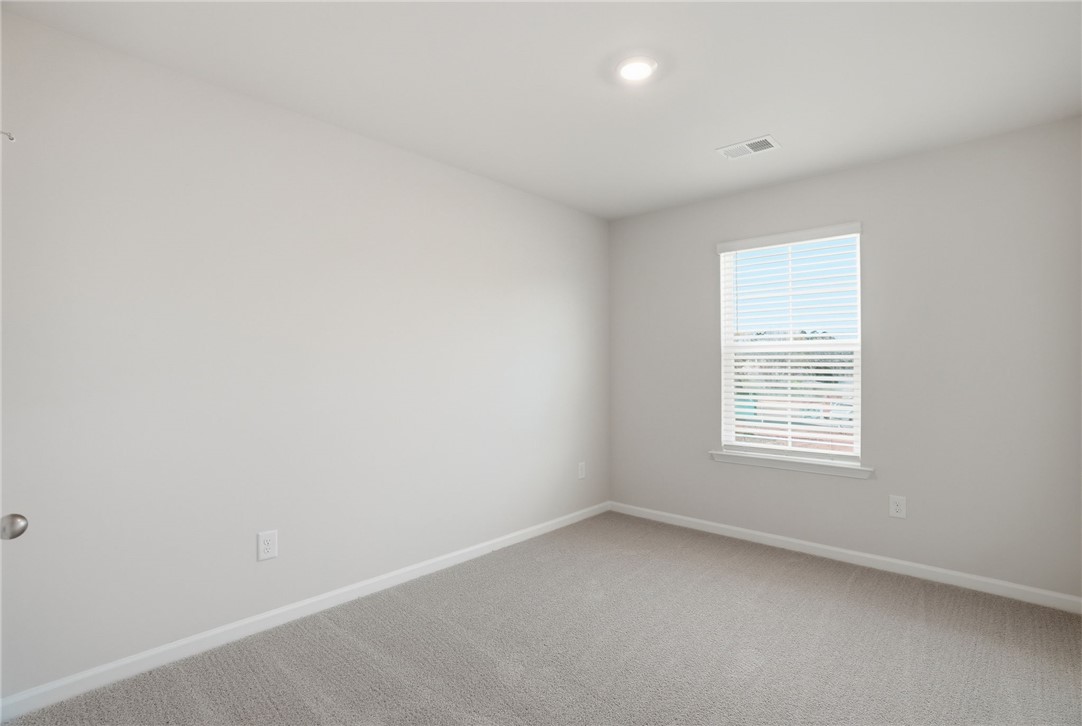 112 Lilac Loop Greenwood, SC 29649 - Photo 14 of 26 This bright and airy room features soft carpeting and natural light, creating a comfortable living space.