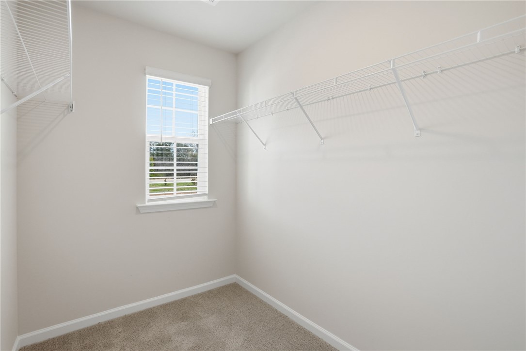 112 Lilac Loop Greenwood, SC 29649 - Photo 23 of 26 This spacious walk-in closet offers ample storage and natural light.