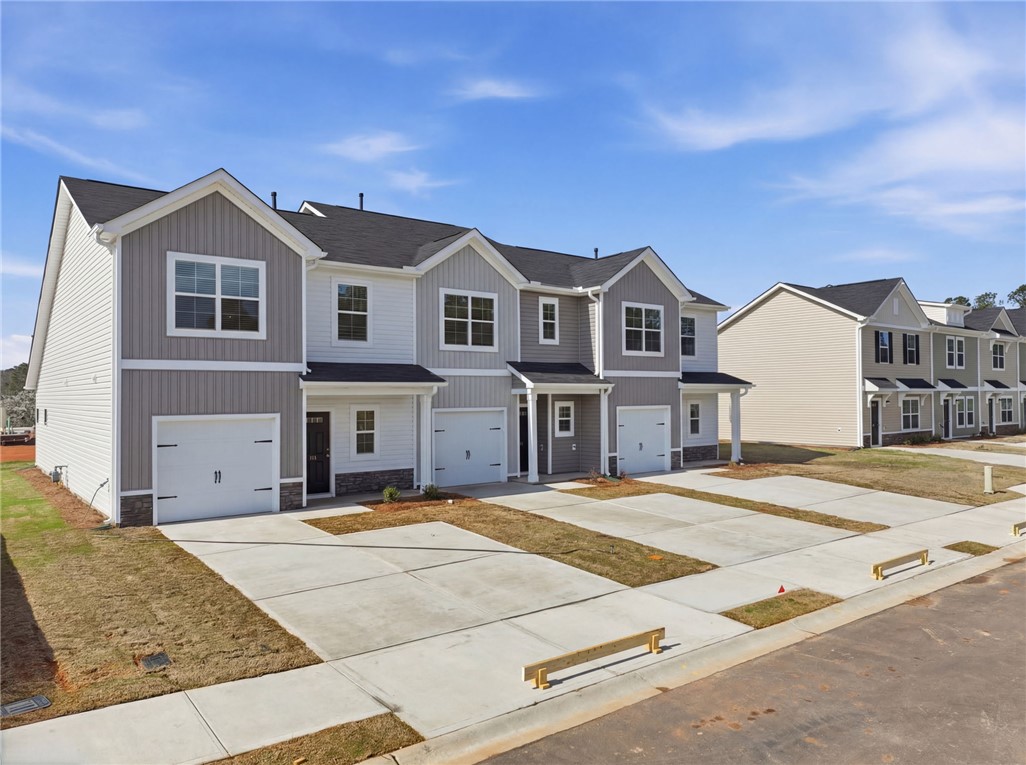 112 Lilac Loop Greenwood, SC 29649 - Photo 3 of 26 These modern townhomes offer convenient living with private garages and contemporary design.