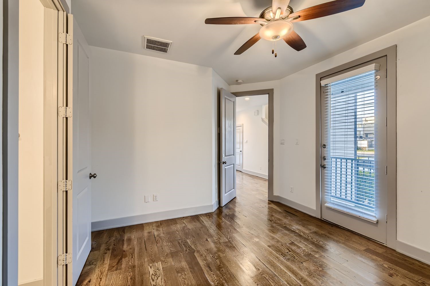 2208 Arabelle Street Houston, TX 77007 - Photo 18 of 26 a view of empty room with wooden floor and fan