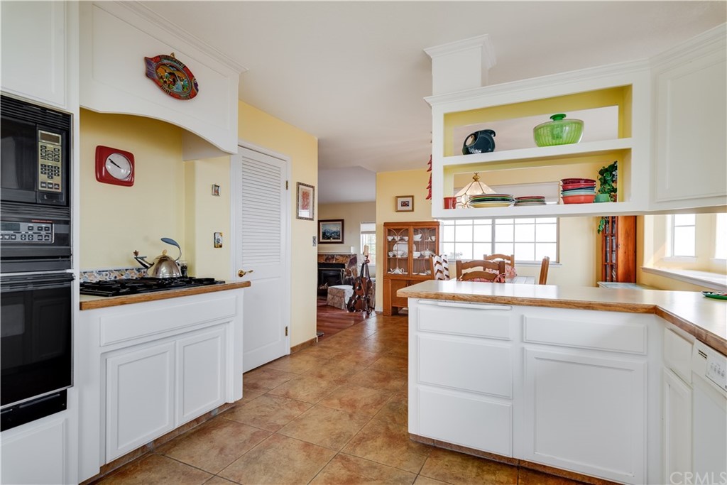 7250 Rancho Verano Place Paso Robles, CA 93446 - Photo 11 of 49 a kitchen with stainless steel appliances granite countertop a sink and cabinets
