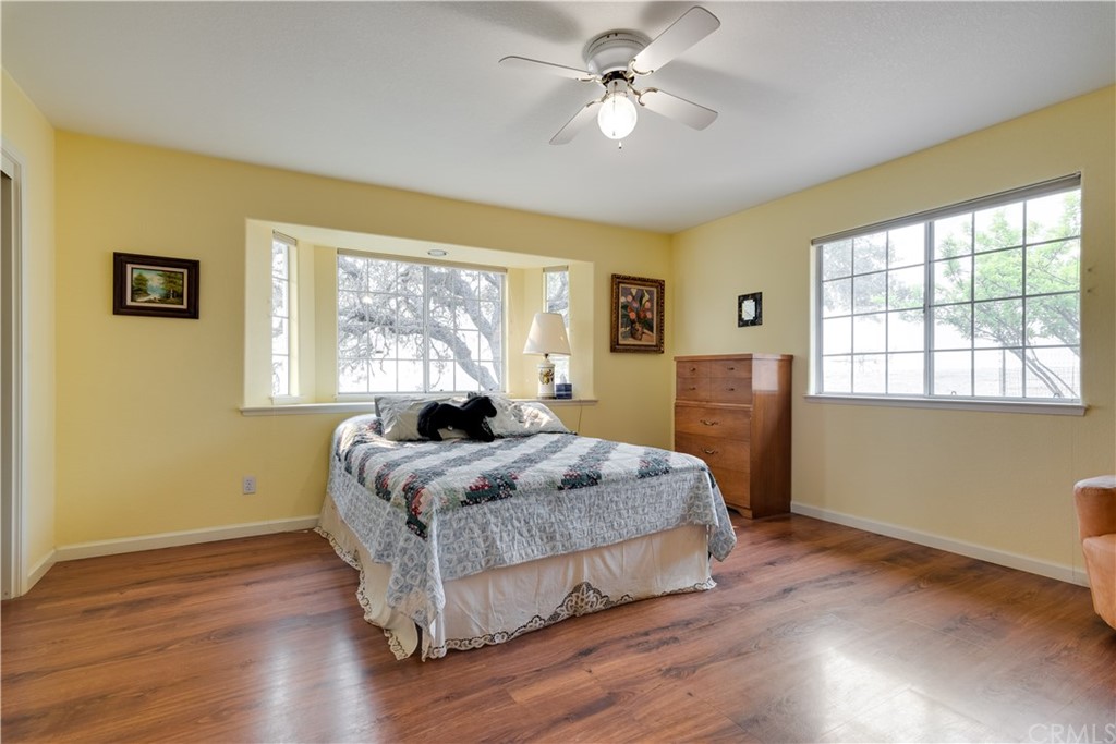 7250 Rancho Verano Place Paso Robles, CA 93446 - Photo 12 of 49 a bedroom with a bed and wooden floor