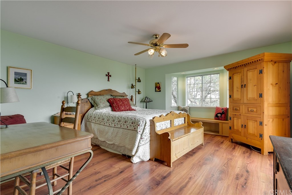7250 Rancho Verano Place Paso Robles, CA 93446 - Photo 15 of 49 a bedroom with a bed and wooden floor