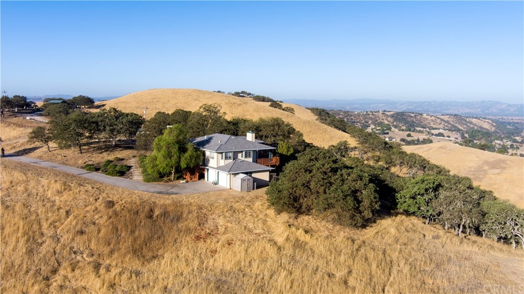 7250 Rancho Verano Place Paso Robles, CA 93446 - Photo 41 of 49 an aerial view of a house with a yard and mountain view in back