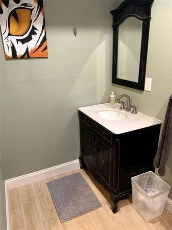 a bathroom with a sink vanity and mirror