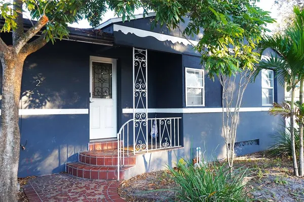 a view of a house with a small yard and a garden