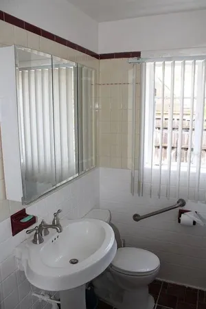 a bathroom with a sink a toilet and tub