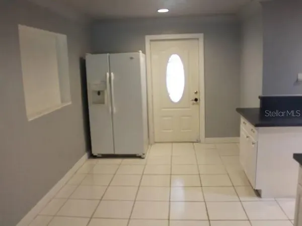 an empty room with wooden floor and cabinet