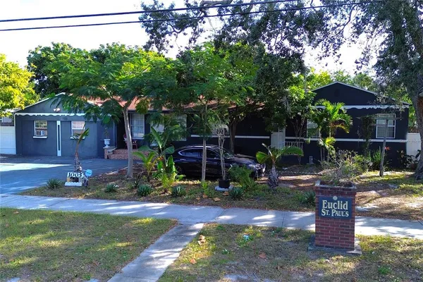 a view of a house with backyard and sitting area