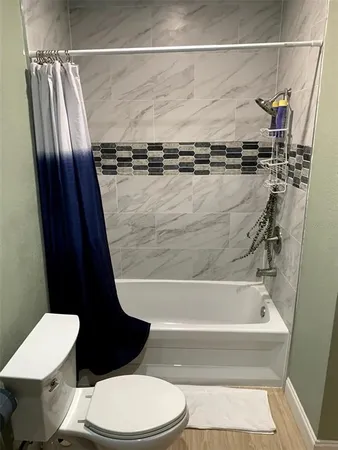 a bathroom with a toilet and a shower
