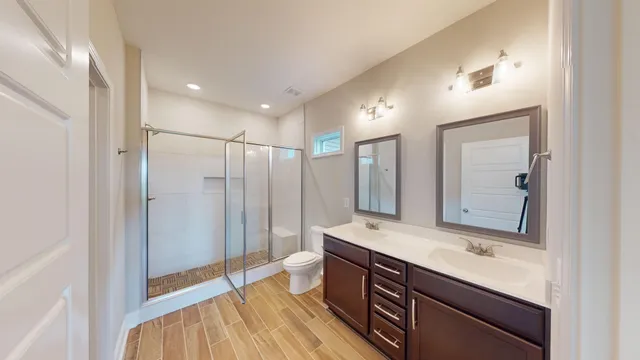 a bathroom with a sink mirror and a shower