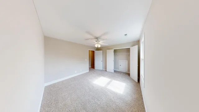 a view of a livingroom with a ceiling fan and window