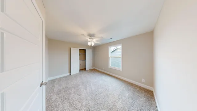 an empty room with windows and closet