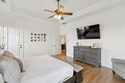 a bedroom with a bed and a flat screen tv