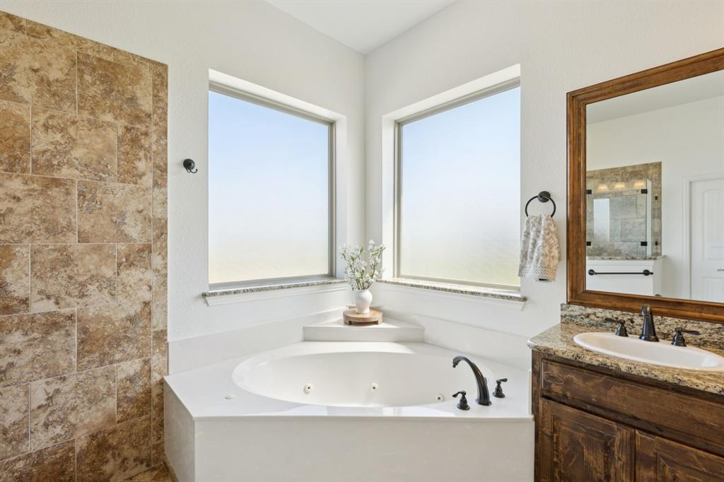6824 Katie Corral Drive Fort Worth, TX 76126 - Photo 19 of 39 a bathroom with a granite countertop sink and a bathtub