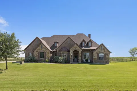 a front view of a house with a garden and bathtub