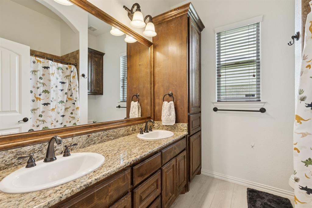 6824 Katie Corral Drive Fort Worth, TX 76126 - Photo 21 of 39 a bathroom with a granite countertop sink and a mirror