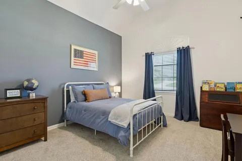 a bedroom with a bed and a dresser